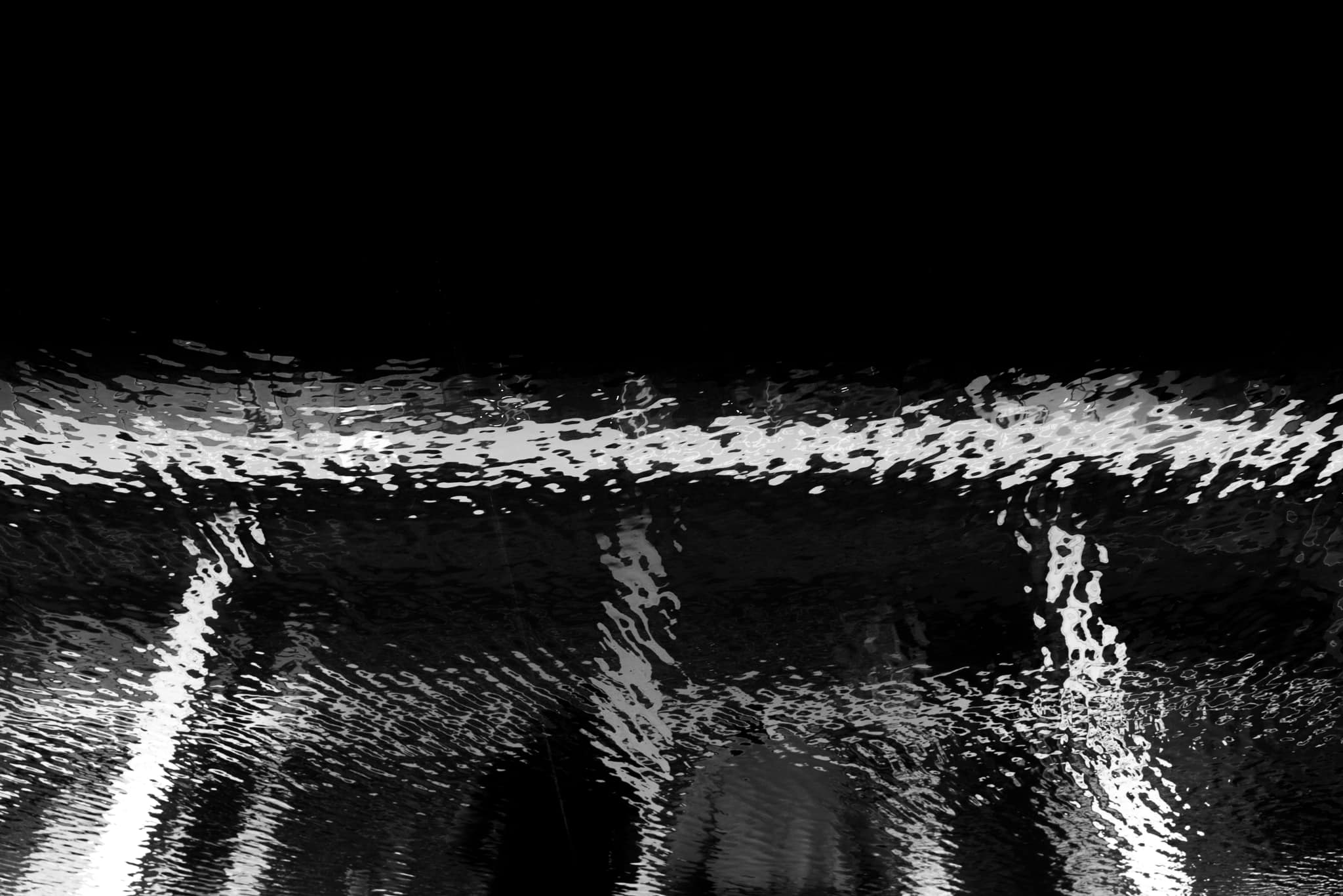 Silhouette of couple in puddle reflection