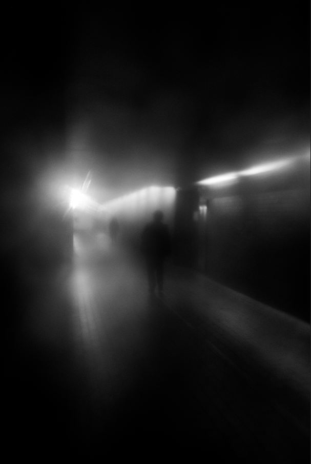 misted image of person waiting for a train 